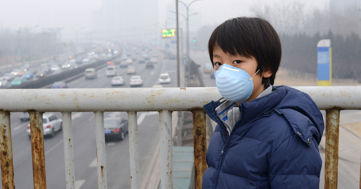 Air pollution with boy wearing face mask