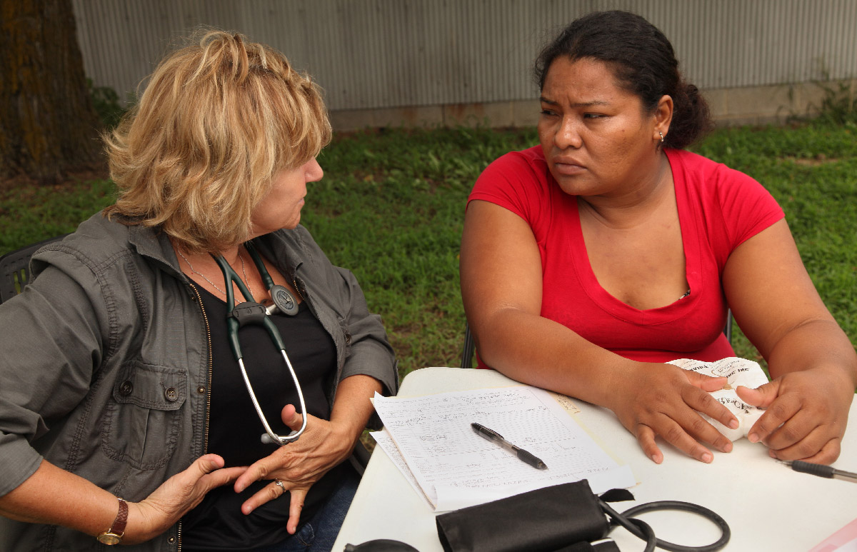 Clinician talks with patient in the field