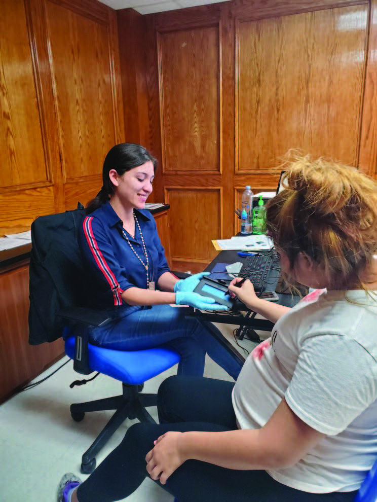 Nahiely “Pinky” Garcia assists a patient in registering with Health Network.