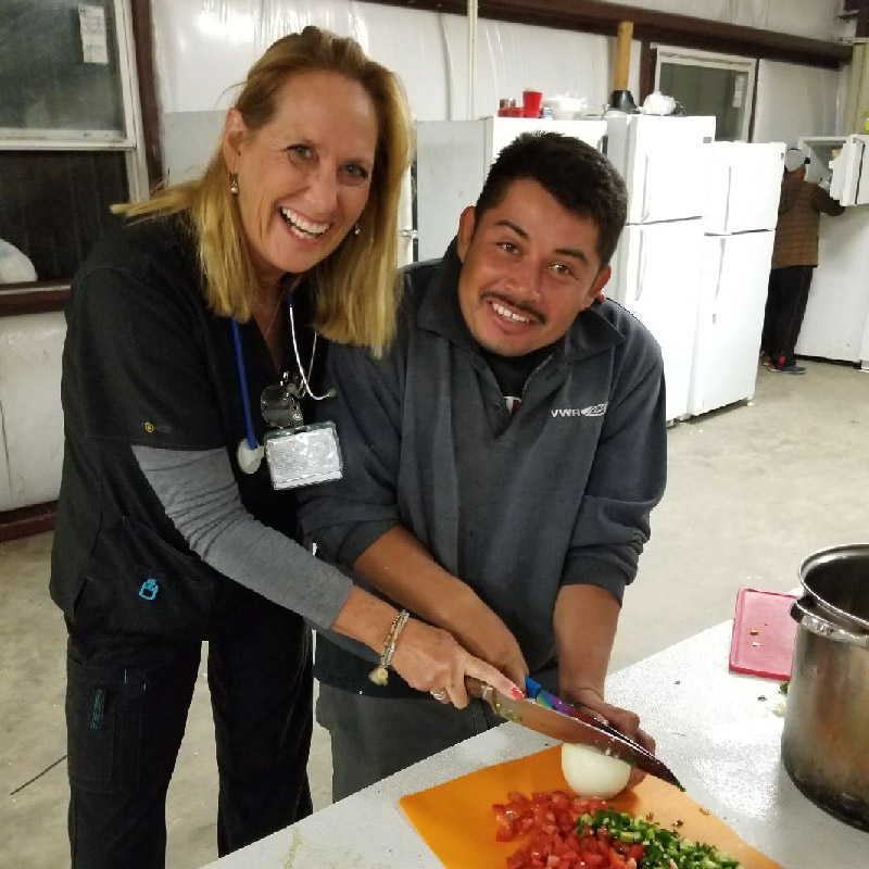 Gena Byrd, RN, in the kitchen with H2A farmworkers