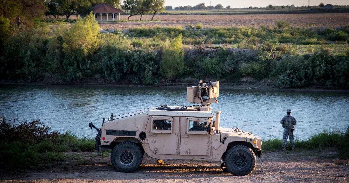 A member of the National Guard watches a portion of the Rio Grande river