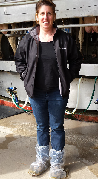 Amy wearing protective shoe covers while visiting a dairy farm