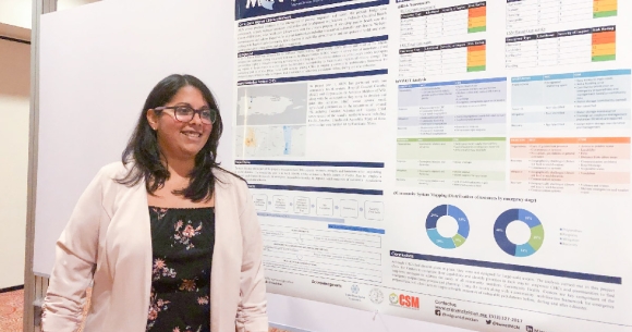 Marysel PagÃ¡n Santana poses with the poster she presented at the conference