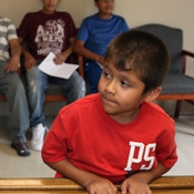 young boy and farmworkers in waiting room