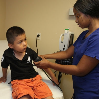 Clinician taking child's blood pressure