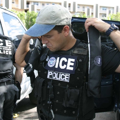 ICE agent putting on gear