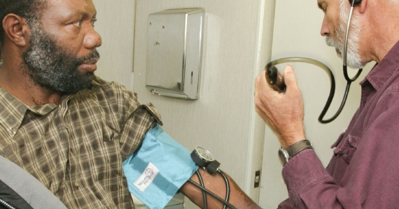 Doctor takes blood pressure of agricultural worker