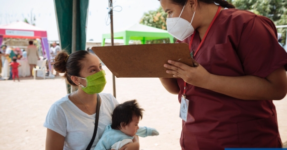 Nurse speaks with woman and child