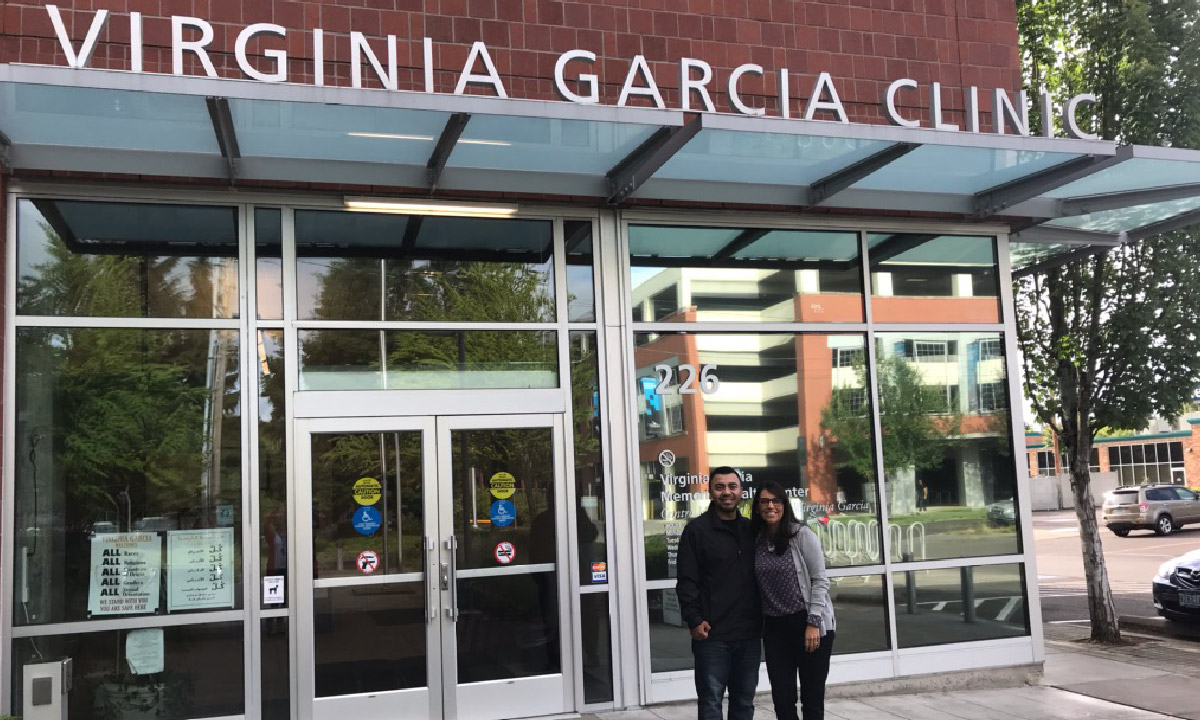 Kevin Alfaro-Martinez and Eva Galvez stand in front of health center.