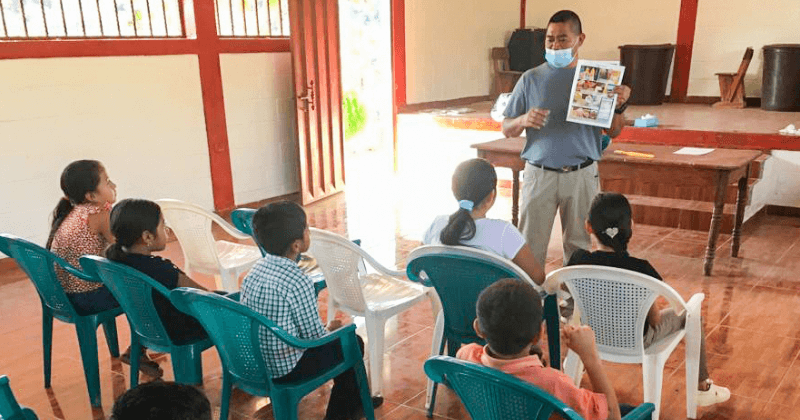 A teacher works with students