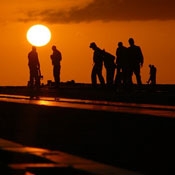 workers in the field at sunset