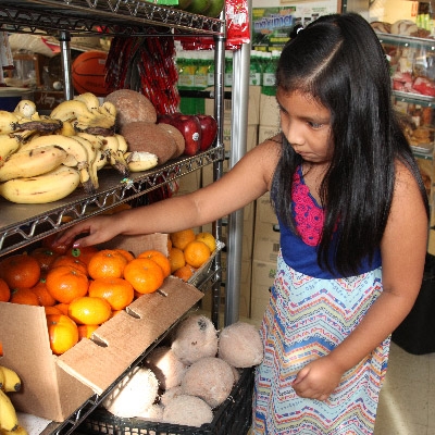 girl buying fruit