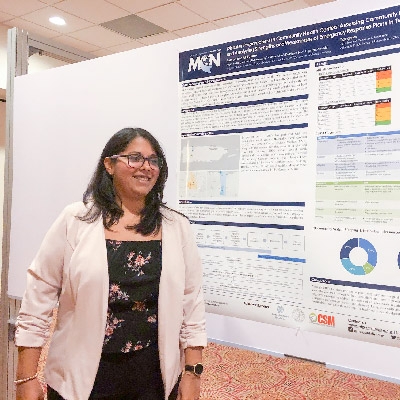 Marysel Pagan Santana poses with the poster she presented at the conference.