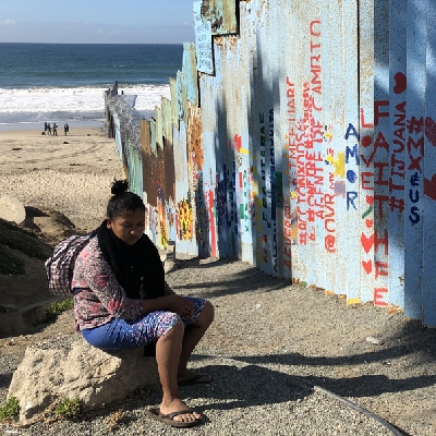 Woman sits on Mexican side of the border