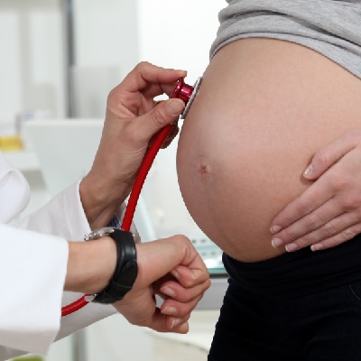 Doctor checks on health of pregnant woman and fetus
